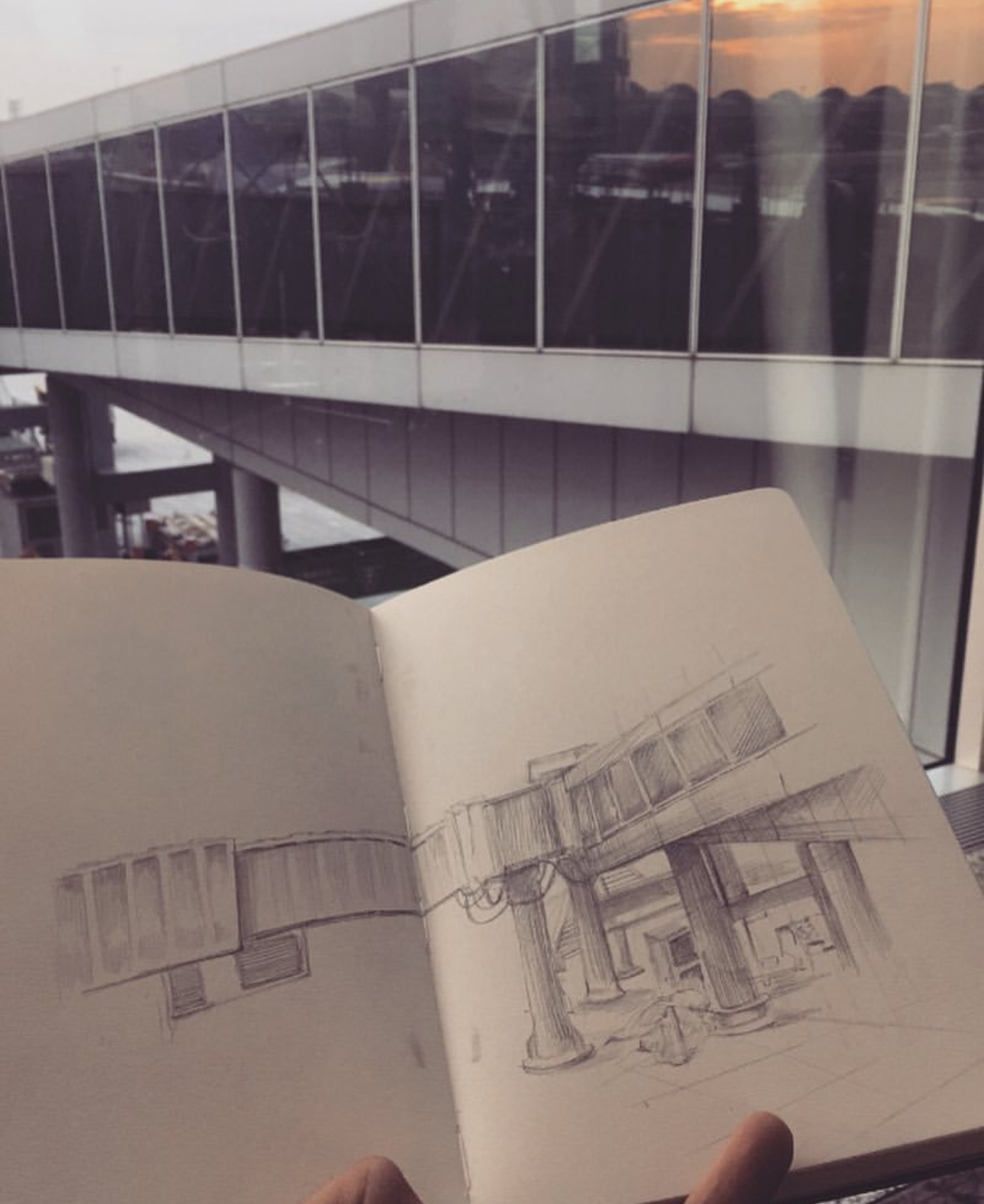 Pencil sketch of a covered walkway, drawn in a notebook at an airport